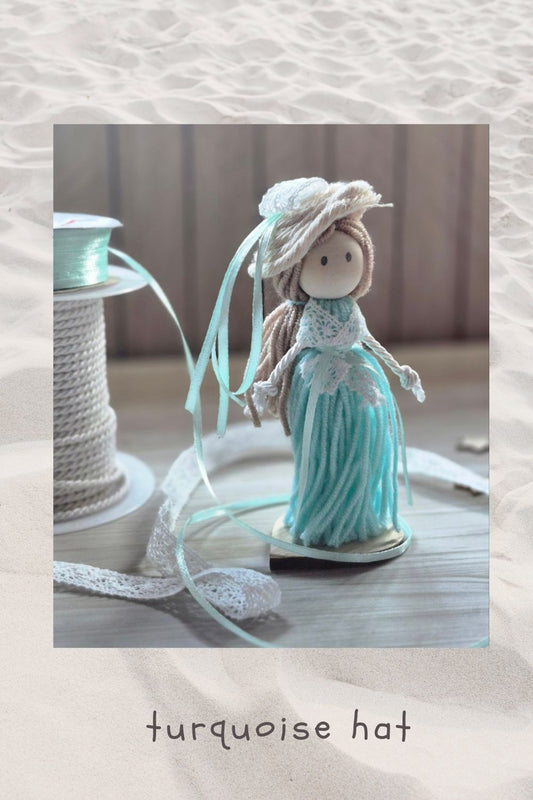 Yarn doll- turquoise hat